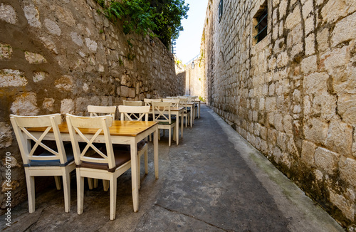 open-air cafe on the narrow street of the old town of Dubrovnik  croatia  vintage architecture  the concept of traveling through the Balkans
