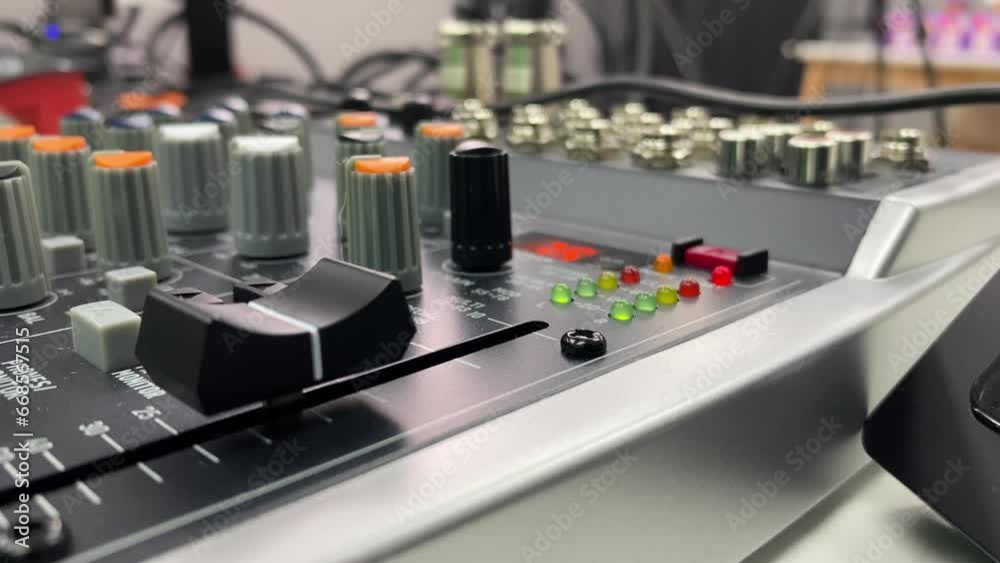 Audio equipment mixer console controller tool close up view. Blurred studio background.