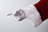 Santa claus hand with gloves pointing and white isolated background