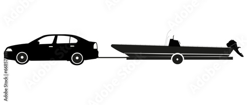 Silhouette de profil d'une voiture tractant un bateau hors-bord  