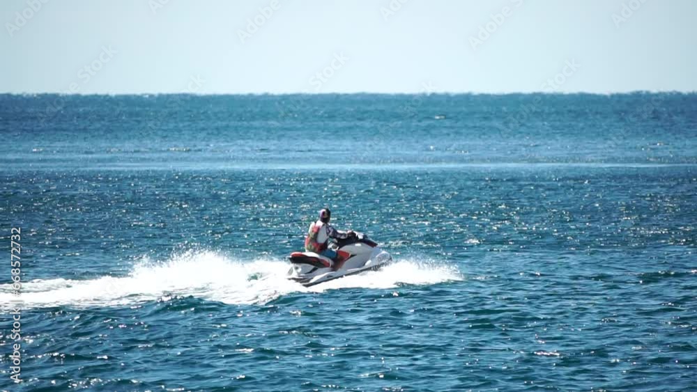 High speed water bike leaving abstract white footprints on the sea water. Aerial top view on Water scooter. Amazing nature background. Water color are beautifully vibrant. Fresh freedom. Adventure day High speed water bike leaving abstract white footprints on the sea water. Aerial top view on Water scooter. Amazing nature background. Water color are beautifully vibrant. Fresh freedom. Adventure day