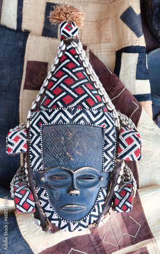 wooden african mask at a flea market , polished with some patina to make it look like an old artifact