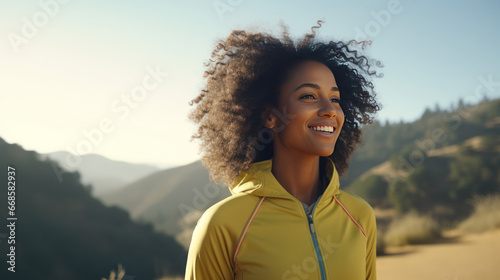 Young African American woman during a walk in the summer national park. Walk in the fresh air, away from the noise of the big city.