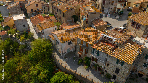 Aerial view of the historic center of Anguillara, in the metropolitan city of Rome, Italy. The roofs of the houses are sloping and have traditional red tiles.
