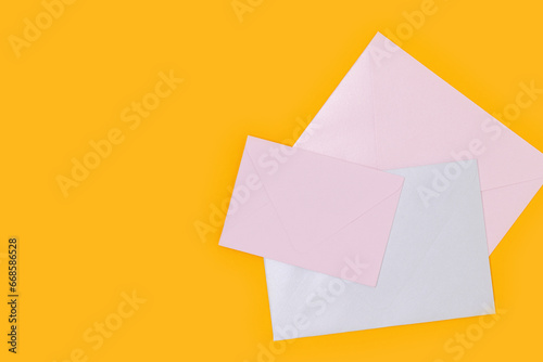 Multicolored envelopes on a yellow background. Minimal concept with place for your design.