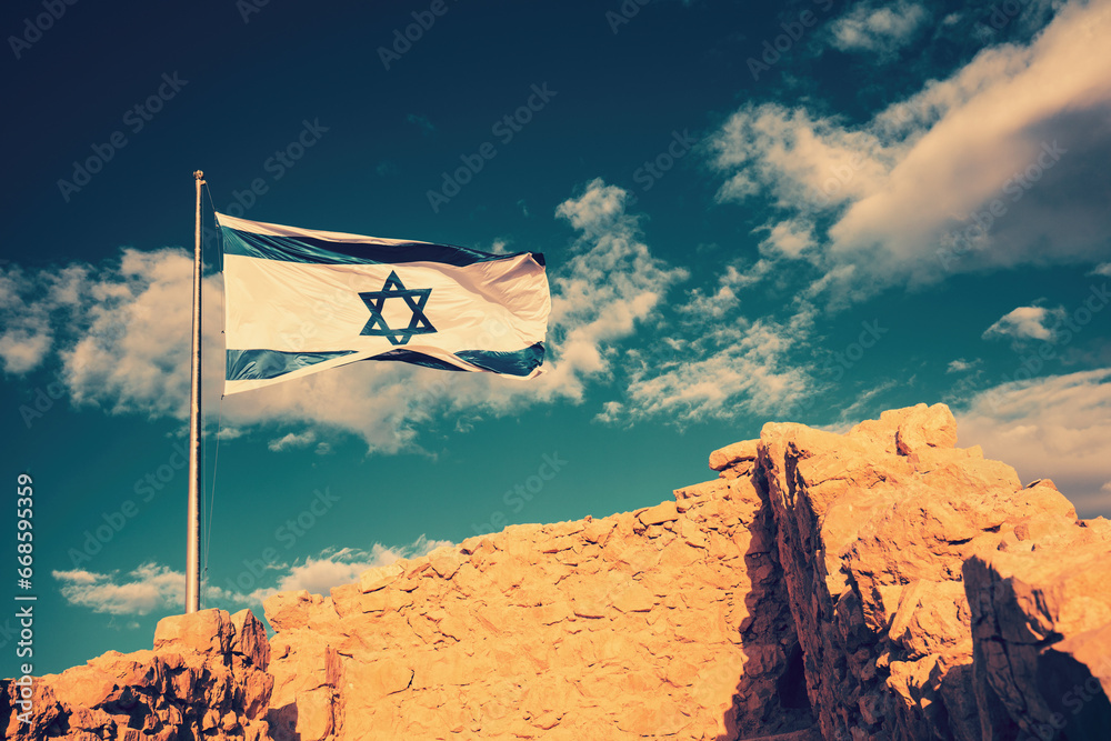 Flag of Israel against the morning sky. Flag of Israel on Masada fortress