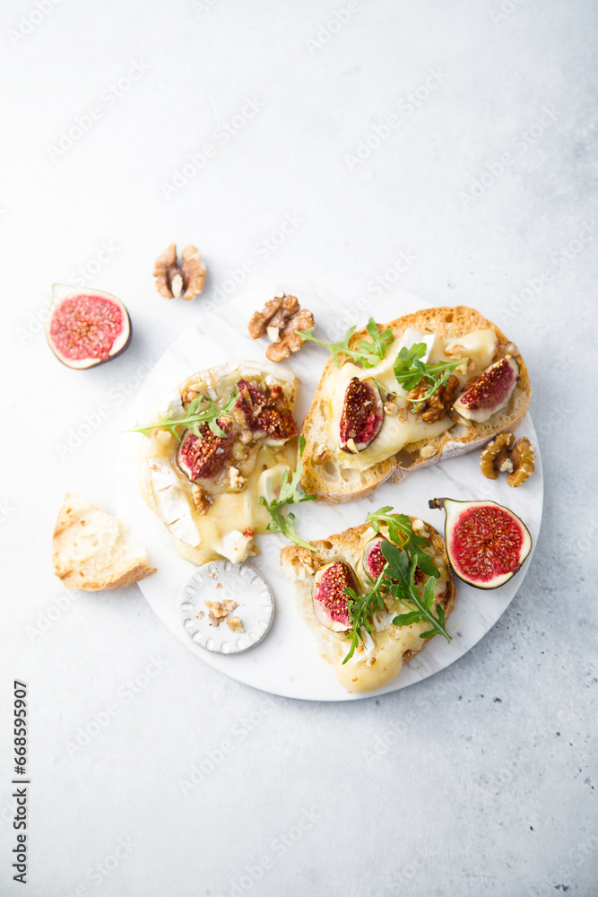 Baked camembert cheese with figs and honey on toast