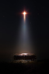 A bright and large star shines brightly, blessing baby Jesus in the manger of the stable. A background and concept that celebrates Christmas and suggests the birth and death of Jesus on the cross.
