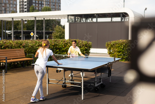 Little children playing ping pong in park