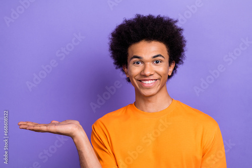 Closeup photo of optimistic promoter new electronics update presentation guy holding hand empty space isolated on violet color background