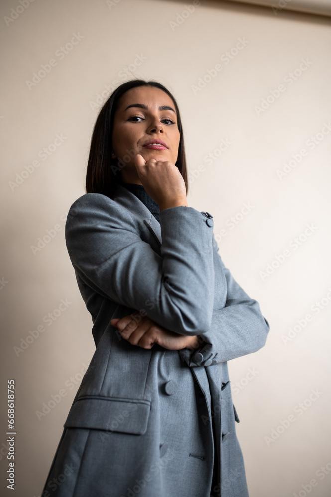 Elegant Fashion Portrait of a Woman in Grey Dress Shirt and Blazer with Brown Hair. Elegant Fashion Portrait of a Woman in Grey Dress Shirt and Blazer with Brown Hair.