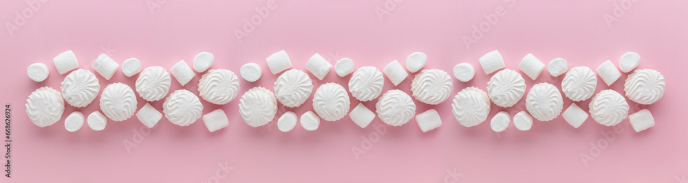 White marshmallows and zephyr on light pastel pink table. Banner with empty space for the text White marshmallows and zephyr on light pastel pink table. Banner with empty space for the text