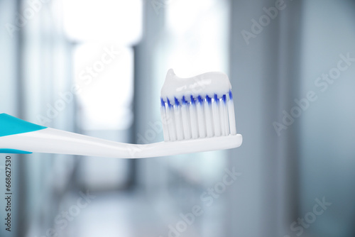 Toothbrush with toothpaste against blurred background  closeup