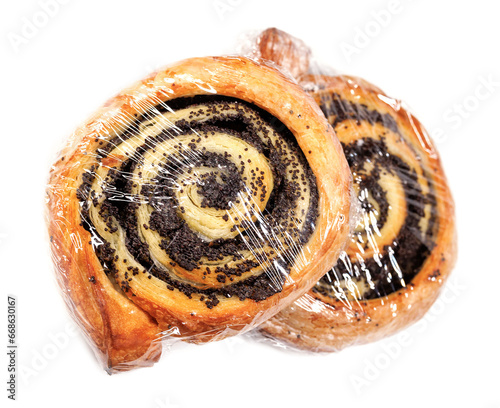 Two buns with poppy seeds wrapped in film isolated on a white background. photo