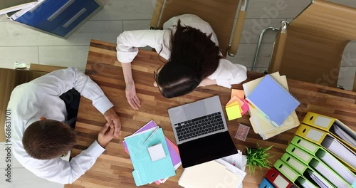 Man and woman arguing bad business contract in office top view. Colleagues have conflictual argument about violating agreement on unacceptable terms photo