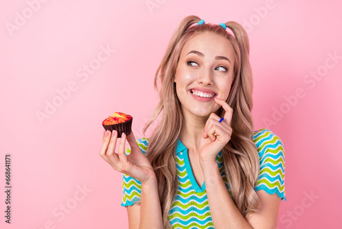 Schilderij op canvas Portrait of toothy beaming girl with tails dressed colorful suit hold cupcake lo