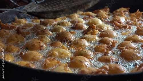 Close up of snacks being fried in a pan, street food stall in India photo