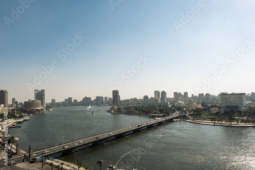 Aerial view of the city of Cairo, the Nile river and the bridge. Towers over the cityscape of this african metropolis. © Adrinson