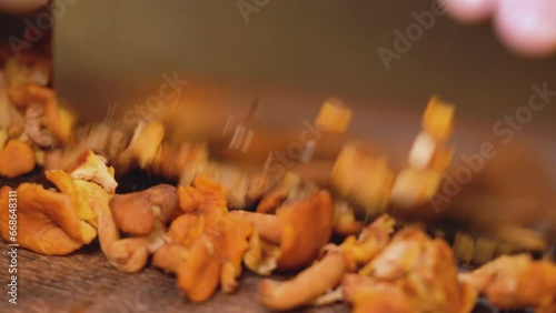 chanterelles cut with a knife on a wooden board