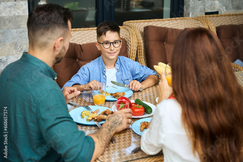 Parents communicate with their son over lunch on the terrace