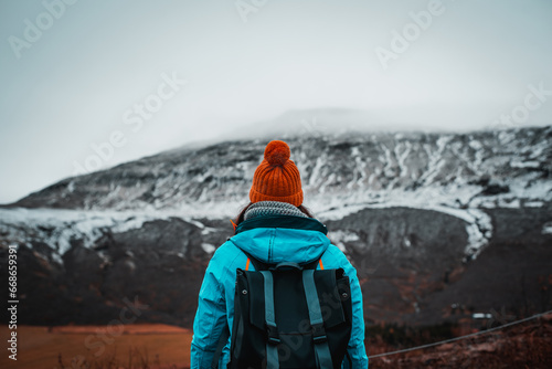 Unrecognizable woman in front of Haukadalur Blesi Geysir, Golden Circle, Iceland