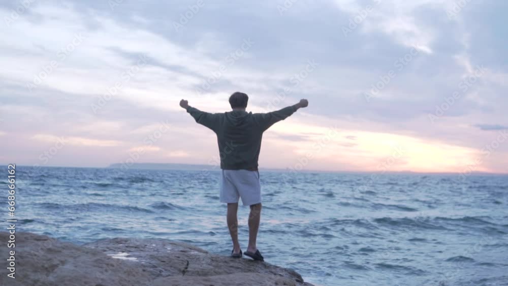  Young Man throwing his hands up in the air, happy and drunk with life