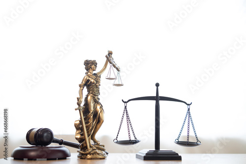 gavel wood Brass scales and a statue of Themis Lady Justice are placed on the tables of the lawyers in the legal counsel\'s office as a symbol of justice. Concept building trust with symbols of justice