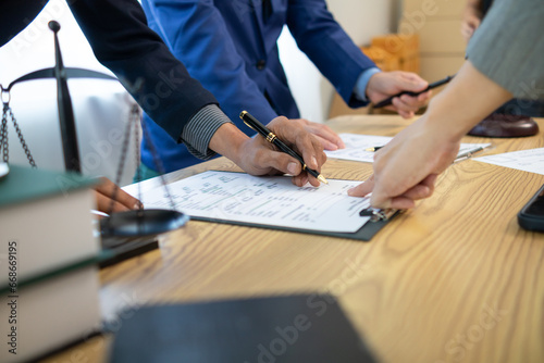 Fototapeta Naklejka Na Ścianę i Meble -  Businessmen and investors sign contract in front of company legal advisor and witness contract for their real estate investment. signing contract between businessman and an investor in front of lawyer