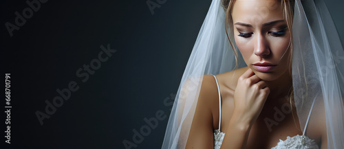 Sad bride in a white wedding dress. Unhappy young woman, failed marriage, forced wedding, family problems.  photo