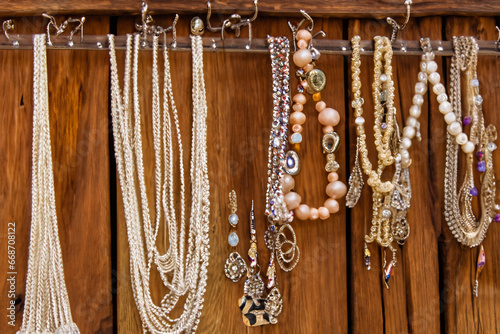 Handmade Jewelry Hanging from Rustic Wood