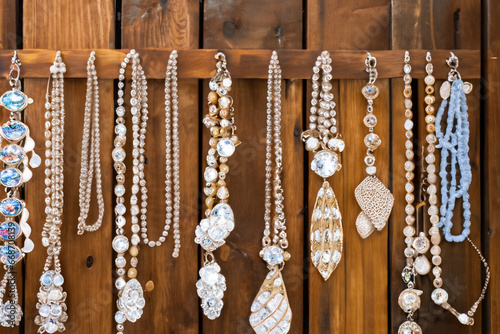 Handmade Jewelry Hanging from Rustic Wood