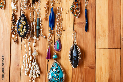 Handmade Jewelry Hanging from Rustic Wood at Craft Fair