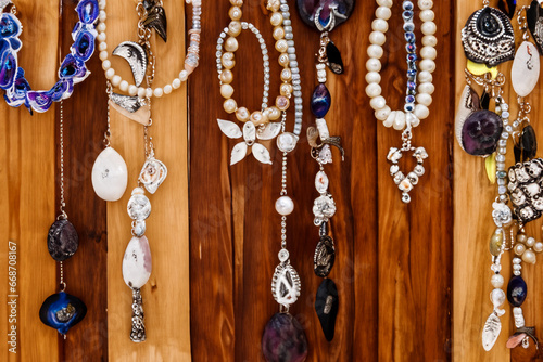 Handmade Jewelry Hanging from Rustic Wood