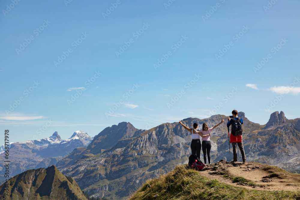 Hikers in the mountains contemplating the view, Stoos, Schwyz, Switzerland

