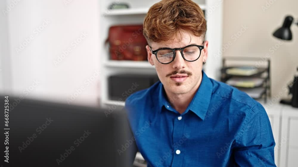 Young hispanic man business worker using computer and smartphone smiling at the office Young hispanic man business worker using computer and smartphone smiling at the office