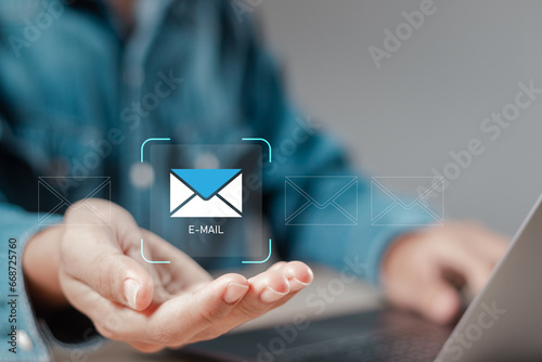 New email notification, businessman holding email symbol for receive new message. business email communication and digital marketing, newsletter, message, sms, electronic communication technology.