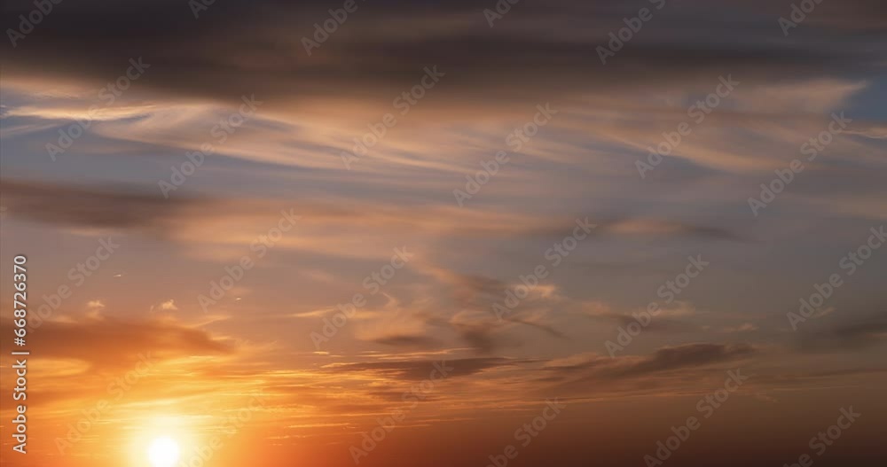 Day to night time lapse. Stunningly beautiful sunset. The sun sets against the background of floating fluffy clouds and paints them in bright fiery colors Day to night time lapse. Stunningly beautiful sunset. The sun sets against the background of floating fluffy clouds and paints them in bright fiery colors