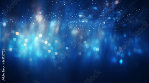 Blue glitter glow particle bokeh background. Festive celebration wallpaper concept © ReneBot/Peopleimages - AI