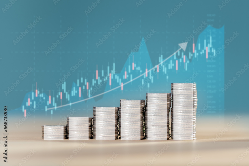 Stacked coins with stock market chart or forex trading chart for invest in trading, graph indicator up and down trend of stock trading with candlestick charts with market fluctuations