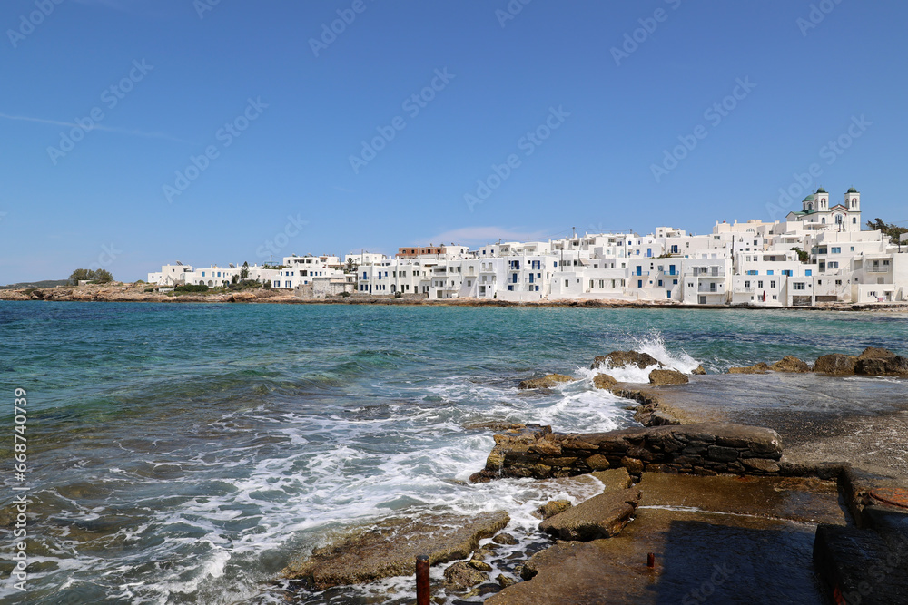 White houses on the coast of Naoussa a small port town in the north of the Greek Cyclades island of Paros