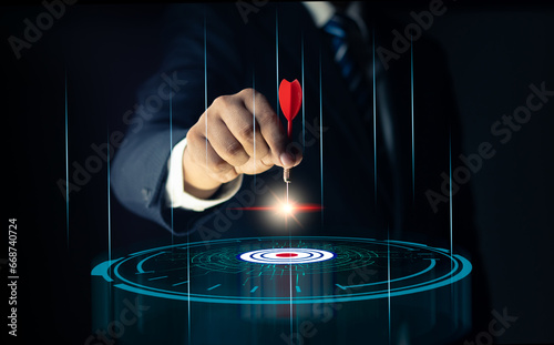 Concept of business strategy and future sustainable business finance action plan. Hand holding target board for creative and set up business objective target and success and business goals concept. photo