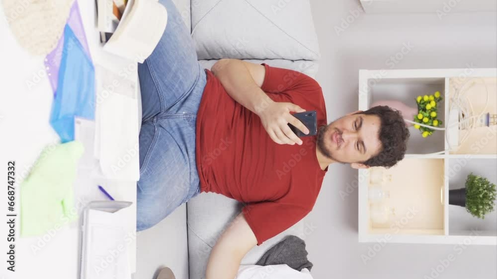 Vertical video of Lazy man laughing at phone in hand and not doing his job. Vertical video of Lazy man laughing at phone in hand and not doing his job.