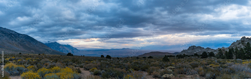 Cloudy morning in the Buttermilks, at the foothills of the Sierra Nevada Mountains in Bishop California. Fall colors and snow capped mountains with large clouds.