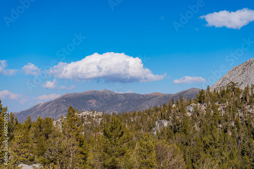 Hiking in Little Lakes Valley in the Eastern Sierra Nevada Mountains outside of Bishop, California. Alpine lakes, fall leaf colors, snow capped mountains and evergreen trees combine to make a pictures