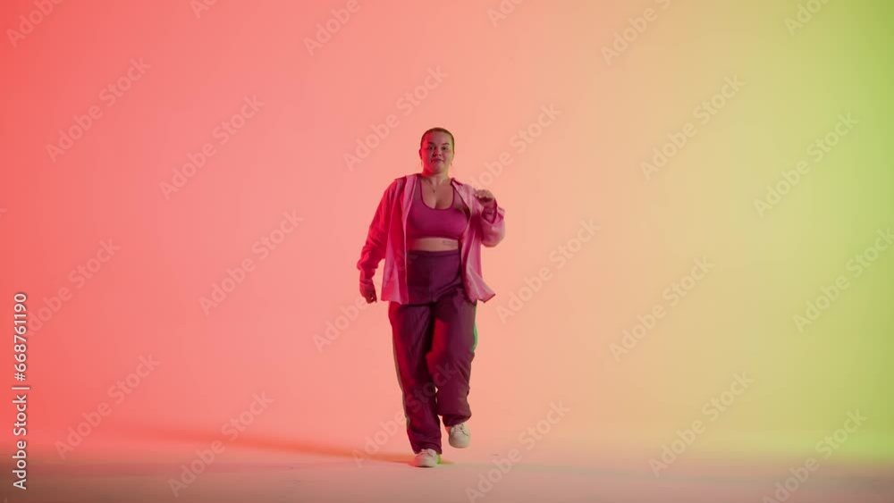 Attractive woman dancing jazz-funk on red and green neon background in a studio. Modern dynamic and energetic dance choreography. Full length. Attractive woman dancing jazz-funk on red and green neon background in a studio. Modern dynamic and energetic dance choreography. Full length.