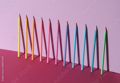 Obraz na płótnie Set of colored pencils on pink background with shadow
