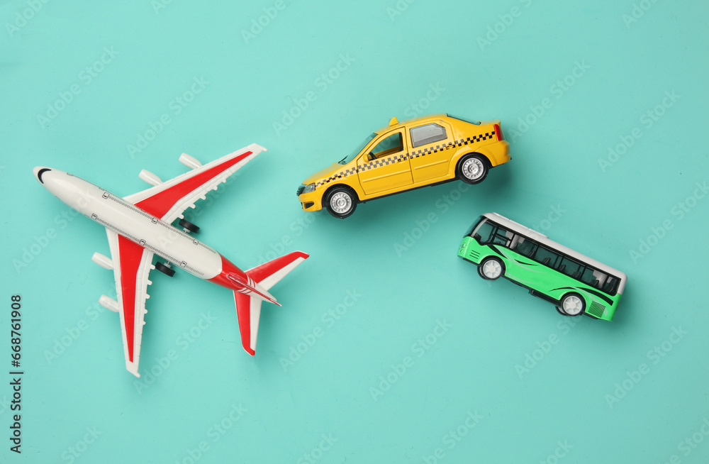 Toy taxi car model with bus and air plane on blue background. Travel concept. Top view
