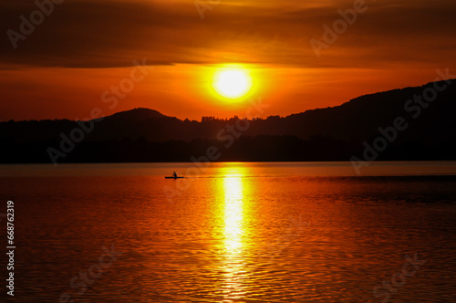 Sunset on lake Pusiano with a kayak in background