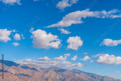 Blue sky and scattered clouds over Sierra Nevada mountains and owens valley at Manzanar National Historic site