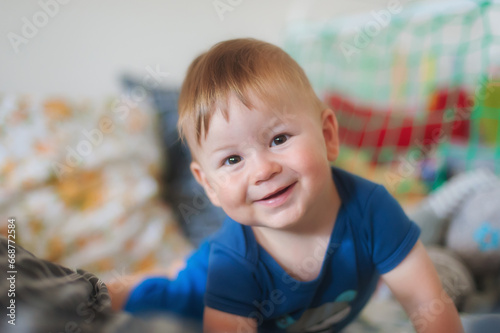 Portrait of cute happy baby boy looking at camera. Joy and happiness concept. Love and family emotion